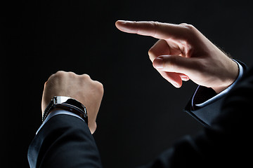 Image showing close up of businessman hands with smart watch