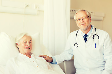 Image showing doctor visiting senior woman at hospital ward