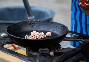 Image showing forcemeat on frying pan at street market