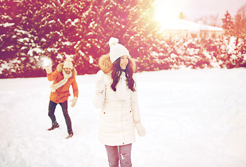 Image showing happy couple playing snowballs in winter