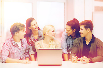 Image showing smiling students with laptop at school