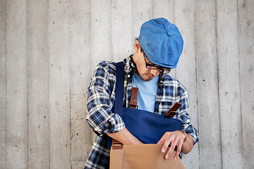 Image showing hipster man looking for something in his bag