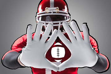 Image showing The hands of american football player on white