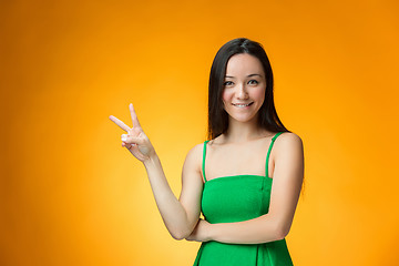 Image showing The happy Chinese girl on yellow background