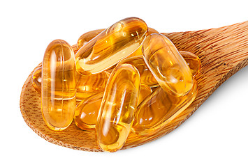 Image showing Cod liver oil omega 3 capsules on wooden spoon