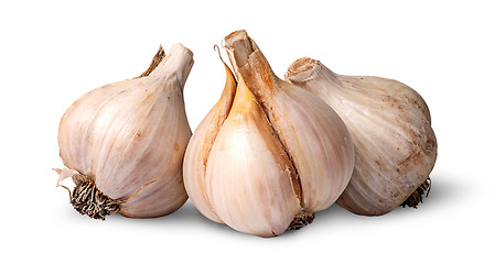 Image showing Three bulbs of garlic beside