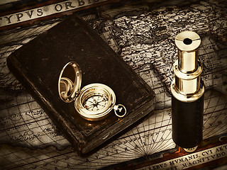 Image showing vintage telescope and compass at antique map