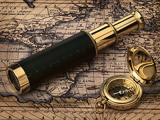 Image showing vintage telescope and compass at antique map