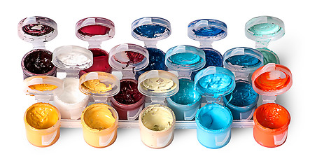 Image showing Set of colorful acrylic paints in open jars