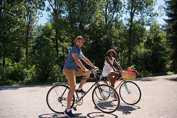 Image showing Young multiethnic couple having a bike ride in nature