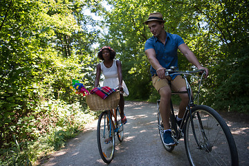 Image showing Young multiethnic couple having a bike ride in nature