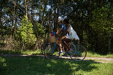 Image showing Young multiethnic couple having a bike ride in nature