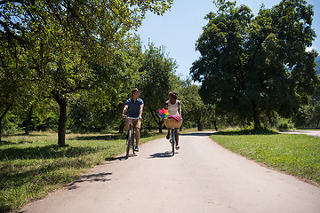 Image showing Young multiethnic couple having a bike ride in nature