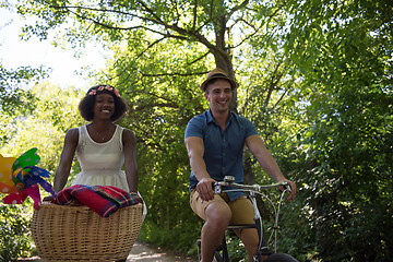 Image showing Young multiethnic couple having a bike ride in nature