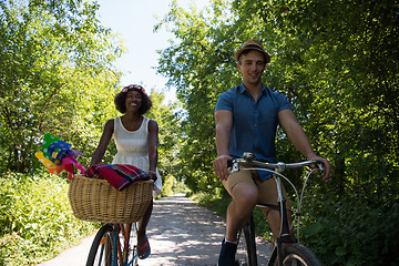 Image showing Young multiethnic couple having a bike ride in nature