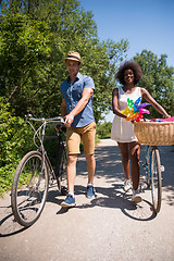 Image showing Young multiethnic couple having a bike ride in nature