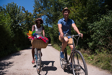 Image showing Young multiethnic couple having a bike ride in nature