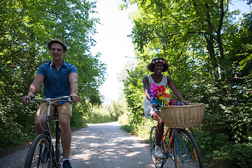 Image showing Young multiethnic couple having a bike ride in nature