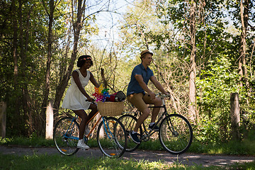 Image showing Young multiethnic couple having a bike ride in nature