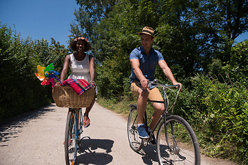 Image showing Young multiethnic couple having a bike ride in nature