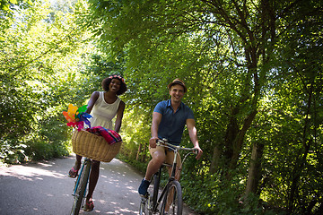 Image showing Young multiethnic couple having a bike ride in nature