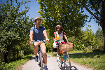 Image showing Young multiethnic couple having a bike ride in nature