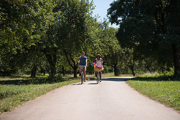 Image showing Young multiethnic couple having a bike ride in nature