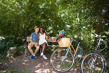 Image showing Young multiethnic couple having a bike ride in nature