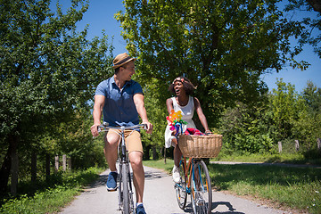 Image showing Young multiethnic couple having a bike ride in nature