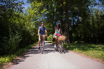 Image showing Young multiethnic couple having a bike ride in nature