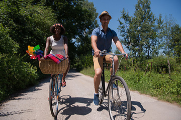 Image showing Young multiethnic couple having a bike ride in nature