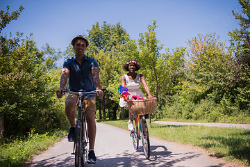 Image showing Young multiethnic couple having a bike ride in nature