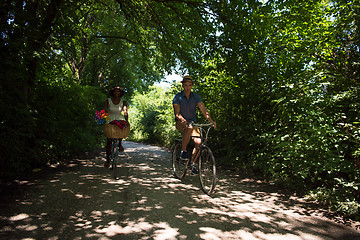 Image showing Young multiethnic couple having a bike ride in nature