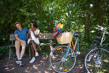 Image showing Young multiethnic couple having a bike ride in nature