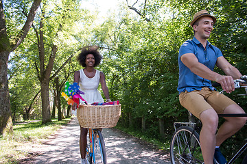 Image showing Young multiethnic couple having a bike ride in nature