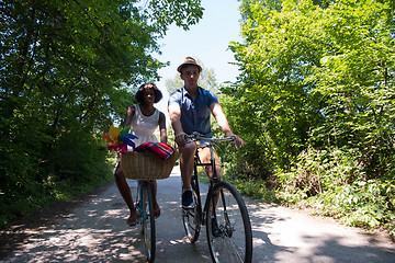 Image showing Young multiethnic couple having a bike ride in nature