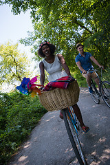 Image showing Young multiethnic couple having a bike ride in nature