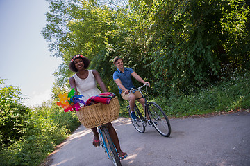 Image showing Young multiethnic couple having a bike ride in nature