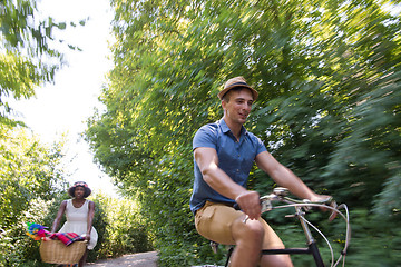 Image showing Young multiethnic couple having a bike ride in nature