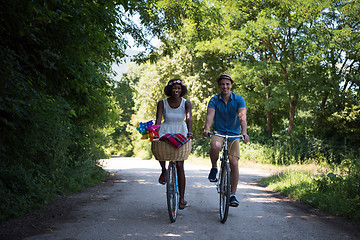 Image showing Young multiethnic couple having a bike ride in nature