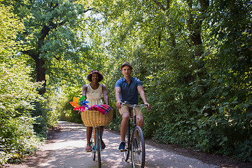 Image showing Young multiethnic couple having a bike ride in nature