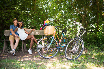 Image showing Young multiethnic couple having a bike ride in nature