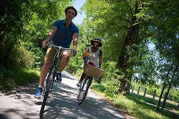 Image showing Young multiethnic couple having a bike ride in nature