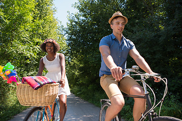 Image showing Young multiethnic couple having a bike ride in nature