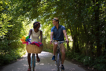 Image showing Young multiethnic couple having a bike ride in nature