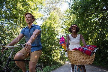 Image showing Young multiethnic couple having a bike ride in nature