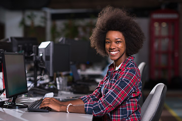 Image showing portrait of a young African American woman in modern office