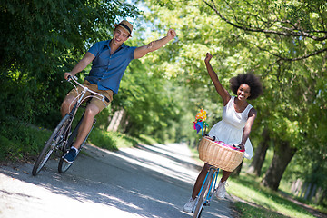 Image showing Young multiethnic couple having a bike ride in nature