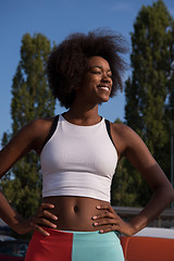 Image showing Portrait of sporty young african american woman running outdoors