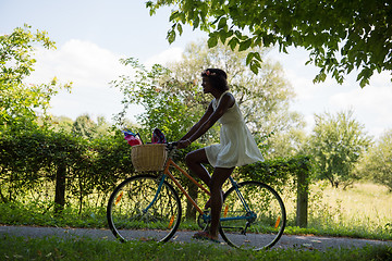 Image showing Young multiethnic couple having a bike ride in nature